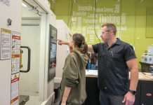 HELPING HAND: Brian Dacier, an instructor for William M. Davies, Jr. Career & Technical High School in Lincoln, works with senior student Taliya Robillard-Montas, who is part of the school’s advanced manufacturing program.  PBN PHOTO / MICHAEL SALERNO