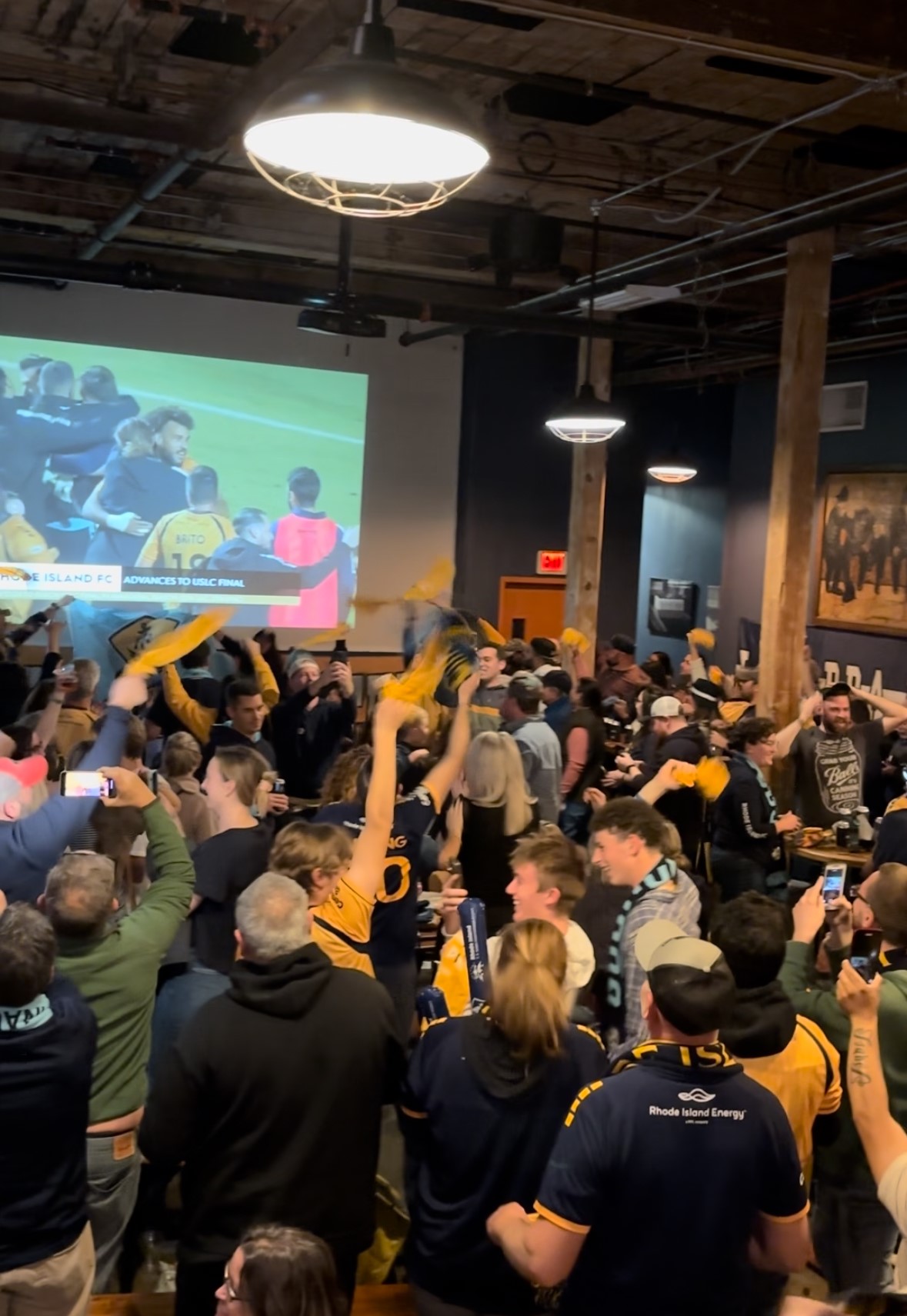 RHODE ISLAND FC fans celebrate Nov. 16 at the Guild in Pawtucket after the team advanced to the United Soccer League Championship match. / PBN PHOTO / JAMES BESSETTE