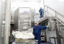 At Amgen Rhode Island, the focus is every action, every person, every time IN THE BAG: Amgen Rhode Island Senior Manufacturing Associate Leandro Castillo, bottom, and manufacturing technician Joe Barter perform a single-use bag inspection and installation to be used for a media and buffer batching process.
PBN PHOTO/ELIZABETH GRAHAM