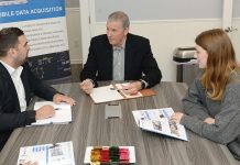 COLLABORATIVE CONFERENCE: Joseph Devine, center, president of Axiotrop LLC, meets with Dewetron Inc. Head of Operations Albon Redzepi, left, and marketing specialist Gabriella Scott at Axiotrop’s Narragansett office.  PBN PHOTO/ELIZABETH GRAHAM
