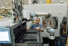 UP TEMPO: James Patnode, a machinist at Hexagon Manufacturing Intelligence Inc., works with a Tempo machine on the company’s manufacturing floor in North Kingstown.  PBN PHOTO / ELIZABETH GRAHAM
