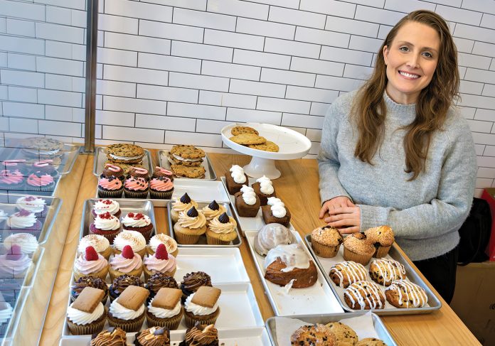 SWEET SUCCESS: After some encouragement from family and friends, Becky Morris started Celebrated LLC, a vegan bakery specializing in wedding desserts. She is pictured at her Richmond shop with an array of her desserts. PBN PHOTO/MICHAEL SALERNO