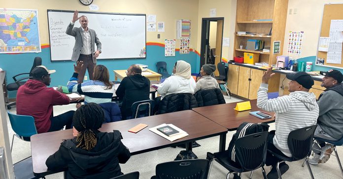 HEAD OF THE CLASS: Justin D. Bibee, Dorcas International Institute of Rhode Island’s Refugee Resettlement Department assistant director, teaches a class at the Providence nonprofit.  COURTESY DORCAS INTERNATIONAL INSTITUTE  OF RHODE ISLAND 