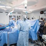 NEW ­OPTION: Kent Hospital surgical team members assist Dr. Brian Temple, second from left in the background, as he performs a DIEP flap procedure as part of breast reconstruction surgery for a mastectomy patient. COURTESY CARE NEW ENGLAND HEALTH SYSTEM