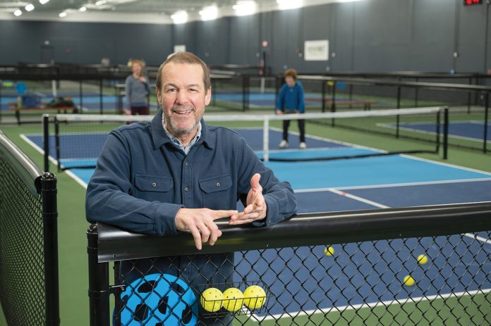 TOGETHER TIME: John Theberge, co-owner of Newport Pickleball Club in Middletown, encourages people to come “enjoy the friendly vibe” of pickleball.  PBN PHOTO/DAVID HANSEN