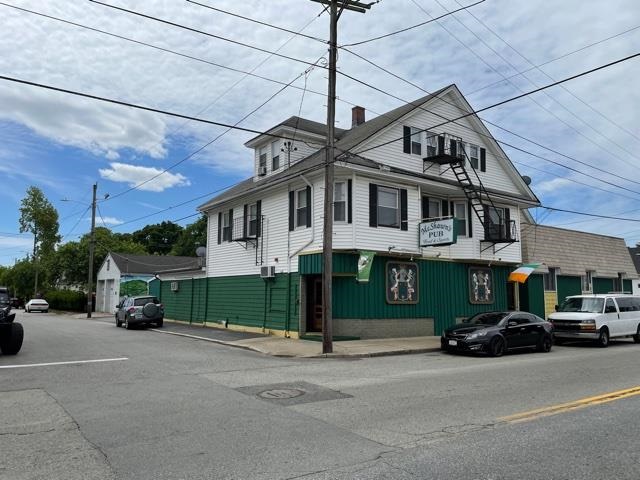 A MIXED-USE PROPERTY at 1336-1340 Cranston St. in Cranston containing a commercial garage, retail space and residential units recently sold for $1.07 million. / COURTESY SWEENEY REAL ESTATE & APPRAISAL