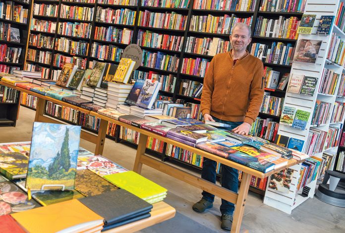 GATHERING PLACE: Scott McCullough loved books growing up and thought he would go into publishing after graduating college, but while working at a bookstore he became passionate about its role in the community and decided to open Symposium Books Inc. in Providence in 2004 with his wife, Anne Marie Keohane.  PBN PHOTO/MICHAEL SALERNO