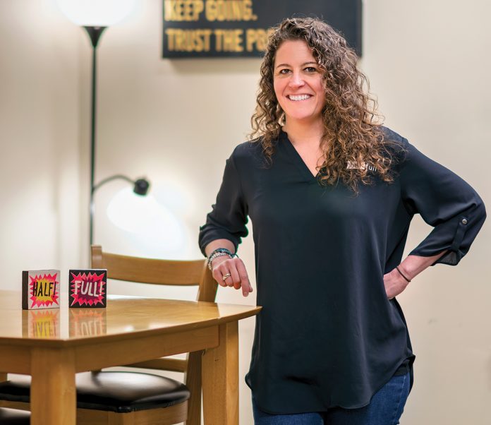PROBLEM-SOLVER: ­Rebecca Twitchell launched workplace consulting firm Half Full LLC with two partners 20 years ago to help companies achieve long-term goals and support their employees. After the Great Recession, Twitchell took over the business and positioned it with a stronger social impact model.   PBN PHOTO/­MICHAEL SALERNO