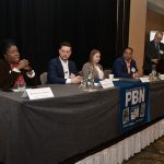 MICHELLE A. REDDISH, left, administrator for the R.I. Cannabis Commission, speaks at Providence Business News' The Business of Cannabis Summit at the Providence Marriott on Thursday. Also on the panel is, from left, Benjamin L. Rackliffe, partner of Pannone Lopes Devereaux & O’Gara LLC; Sasha Gorski, co-owner of Talaria LLC; and Ronald Crosson II, executive director of Urban Ventures Inc. and chairman and so­cial equity officer of the R.I. Cannabis Advisory Board. PBN Editor Michael Mello, standing, moderates. / PBN PHOTO/MIKE SKORSKI 