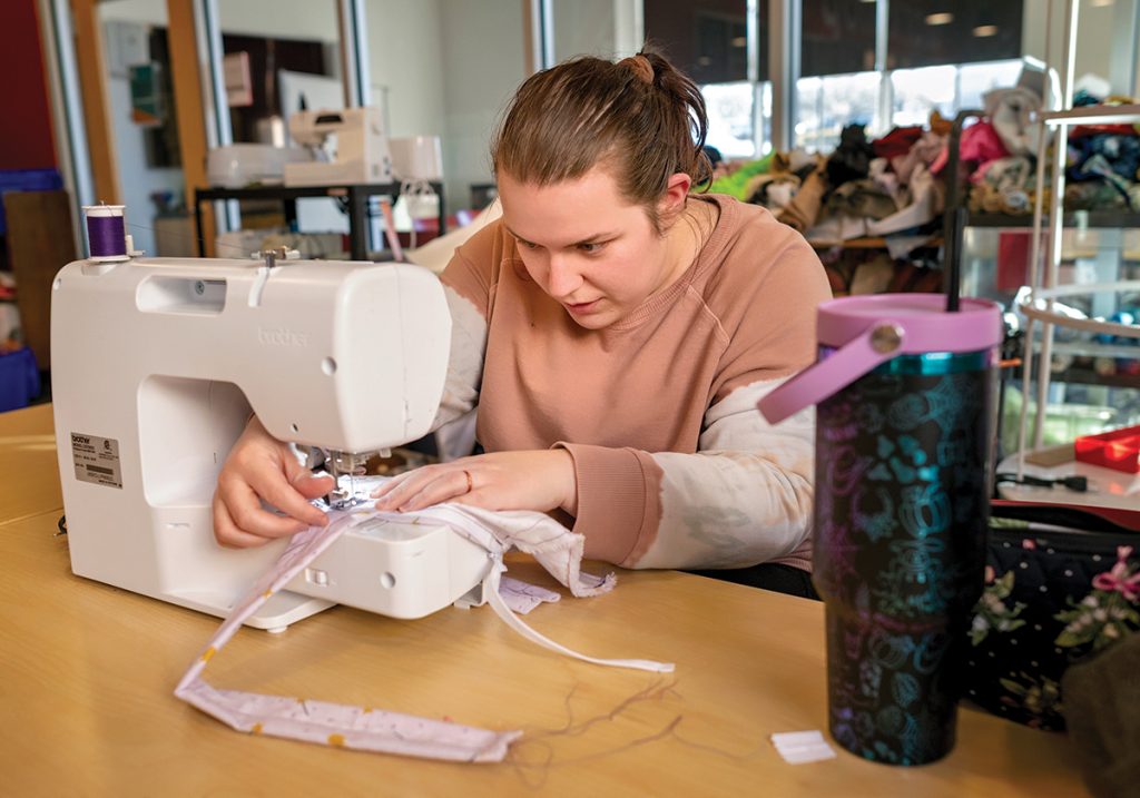 Katt Cook, of Johnston, gets in some equipment training on a sewing machine in the workshop studio, where attendees can also learn laser cutting and 3D printing,
PBN PHOTO/MICHAEL SALERNO
