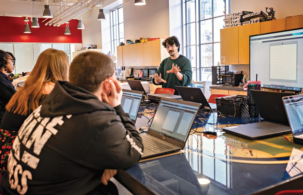 BUSY, BUSY: Owen Cuseo, center, leads a training class on operating vinyl cutters and heat presses at the Providence Public Library.
PBN PHOTO/MICHAEL SALERNO