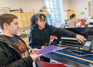 MAKER SPACE: ­Instructor Adaliz Rivera, above right, teaches Jasper Bliss, of Providence, how to operate a heat press and vinyl cutting machine in the first-floor workshop at Providence Public Library.  PBN PHOTO/­MICHAEL SALERNO