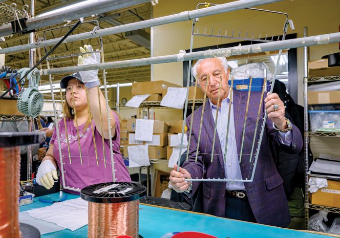 CONSTANT DIVERSIFICATION: Evelyn Gutierrez works on countertop rails for an American-made yacht with Chairman Thomas Tanury at Lincoln-based metal finishing company Tanury Industries. The company used to specialize in jewelry, but now the largest markets it serves are lighting, electronics, aerospace and giftware. PBN PHOTO/MICHAEL SALERNO