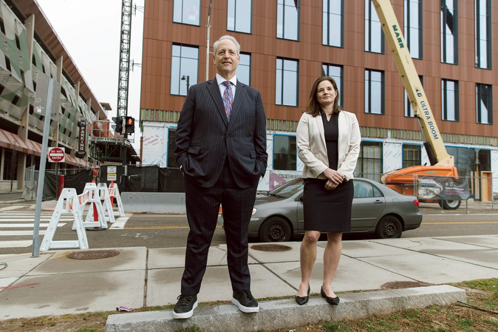 GUIDING HANDS: Marc Crisafulli, left, chairperson of the I-195 Redevelopment District Commission, and Caroline Skuncik, the district’s executive director, outside The PVD Labs building under construction on Richmond Street in Providence. The structure will also house the R.I. State Health Laboratory.  PBN PHOTO/RUPERT WHITELEY