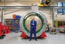 HEAVY METAL: Gregory Mercurio, senior vice president of radiation oncology for American Shared Hospital Services and CEO of Precision Radiation Oncology of Rhode Island, stands in front of a cyclotron, which generates particles that create the protons used in proton beam radiation therapy for cancer patients. The cyclotron must be surrounded by a vault, which together weigh 230,000 pounds. COURTESY GREGORY MERCURIO