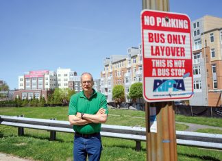 OPPOSED: Randall Rose, a member of the Kennedy Plaza Resilience Coalition, is pictured in front of one of the parcels next to the train station recommended for a new R.I. Public Transit Authority hub. PBN PHOTO/PAUL J. SPETRINI