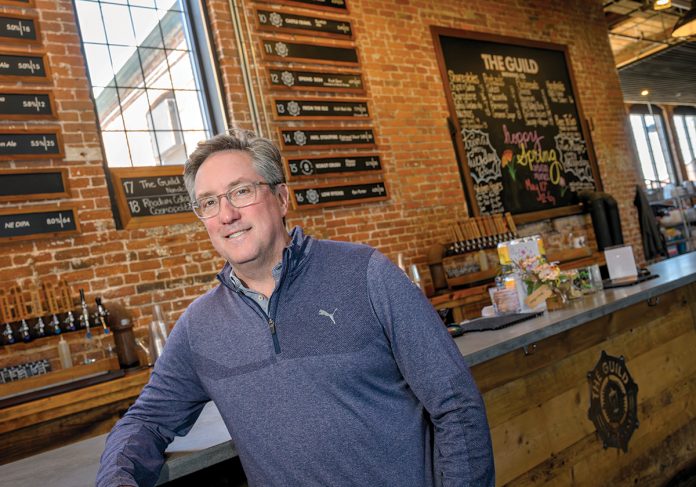 DRINKING UP: Jeremy Duffy, co-founder of Isle Brewers Guild LLC, thinks the Pawtucket-Central Falls Transit Center has helped his business, though others say the station has not noticeably boosted foot traffic along nearby Main Street.  PBN FILE PHOTO/­MICHAEL SALERNO