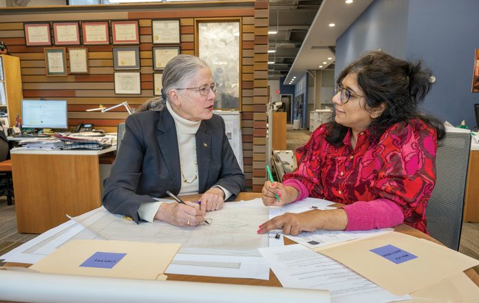 PLAN ­REVIEW: ­Barbara Thornton, left, a partner at Brewster Thornton Group Architects LLP, and Aarti Kathuria, one of the firm’s project managers, go over plans for a project.  PBN FILE PHOTO/­MICHAEL SALERNO