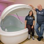 DEEP THERAPY: Float Rhode Island co-owners Lindy Fregeolle and Scott Mitchell with one of their float therapy pods, in which a person floats in a heated mixture of water and Epsom salts, which reduces or eliminates the senses so the mind and body can slow down and relax.  PBN PHOTO/MICHAEL SALERNO
