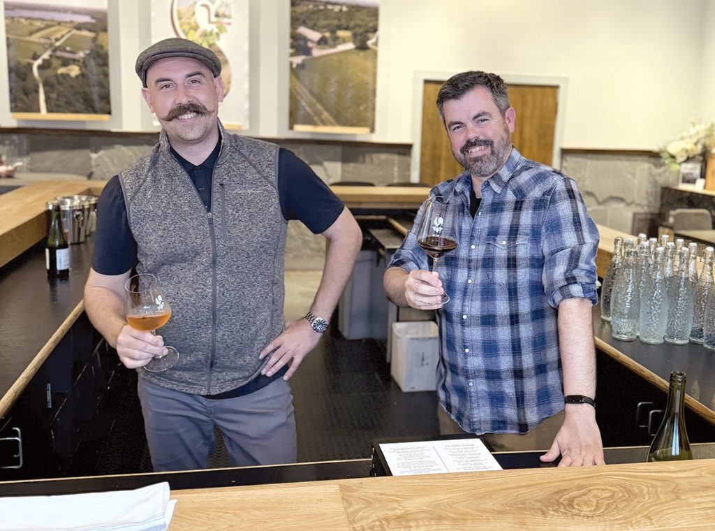 CHEERS: Matt Gant, left, assistant tasting room manager, and Drew Eichinger, sales manager, at Sakonnet Vineyards are pictured in the tasting room at the Little Compton winery.
COURTESY SAKONNET VINEYARDS