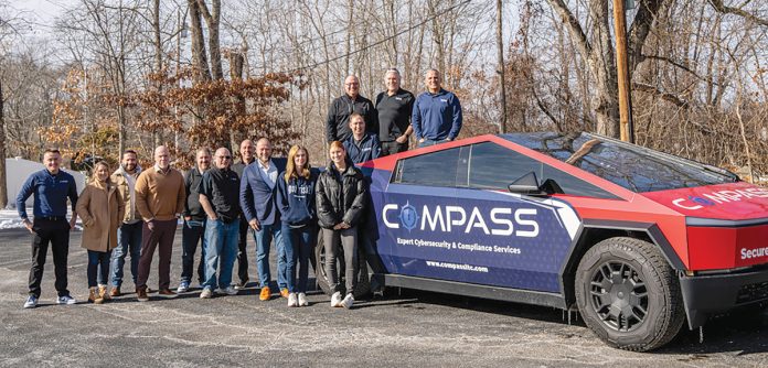 KEEP ON TRUCKING: Members of the Compass IT Compliance LLC team gather at the company’s North Providence headquarters with the company Tesla Cybertruck.  COURTESY COMPASS IT COMPLIANCE LLC