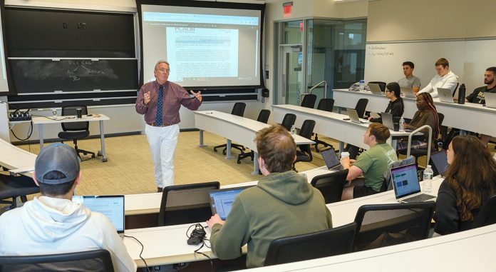 A BIT EMPTY: Charles Cullinan, Bryant University Accounting Department chair and professor, teaches a class at Bryant in Smithfield. He acknowledges that there are fewer students aspiring to become accountants these days.  PBN PHOTO/MICHAEL SALERNO