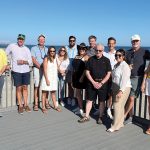 SOAKING IN THE SUN: Duffy & Sweeney Ltd. employees enjoy a day out during the firm’s annual end-of-summer beach party.  COURTESY DUFFY & SWEENEY LTD.