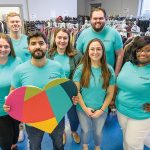 Amica Mutual Insurance Co. WARM FEELING: Amica Mutual Insurance Co. employees gather around donated clothes to distribute them to those in need.
COURTESY AMICA MUTUAL INSURANCE CO.