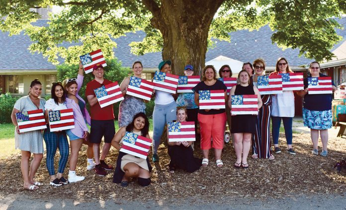 FLAG DAY: Marasco & Nesselbush LLP employees hold up U.S. flag paintings they made during an employee-led paint day.
COURTESY MARASCO & NESSELBUSH LLP FLAG DAY: Marasco & Nesselbush LLP employees hold up U.S. flag paintings they made during an employee-led paint day.
COURTESY MARASCO & NESSELBUSH LLP