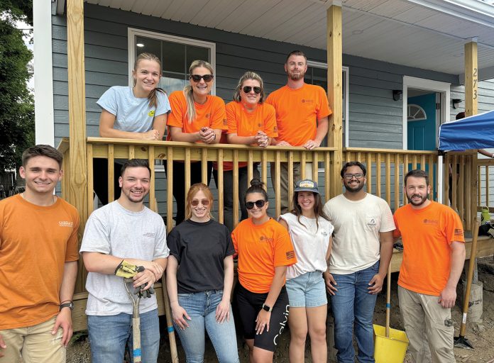 HOME SWEET HOME: New England Construction Inc. employees build a new house as part of a Habitat for Humanity project.  COURTESY NEW ENGLAND CONSTRUCTION
