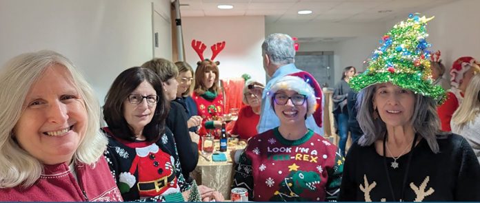 CHRISTMAS SPIRIT: Partridge Snow & Hahn LLP staffers don festive attire at the law firm’s annual holiday party.  COURTESY PARTRIDGE SNOW & HAHN LLP