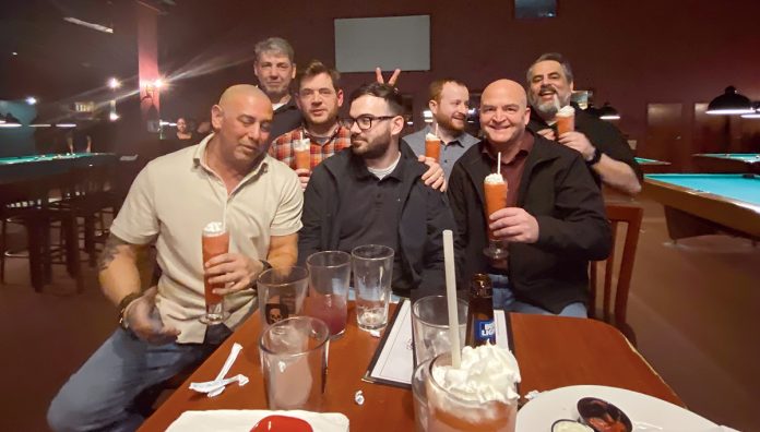 CORNER POCKET: Technology Advisory Group LLC employees enjoy an evening playing billiards recently.  COURTESY TECHNOLOGY ADVISORY GROUP LLC