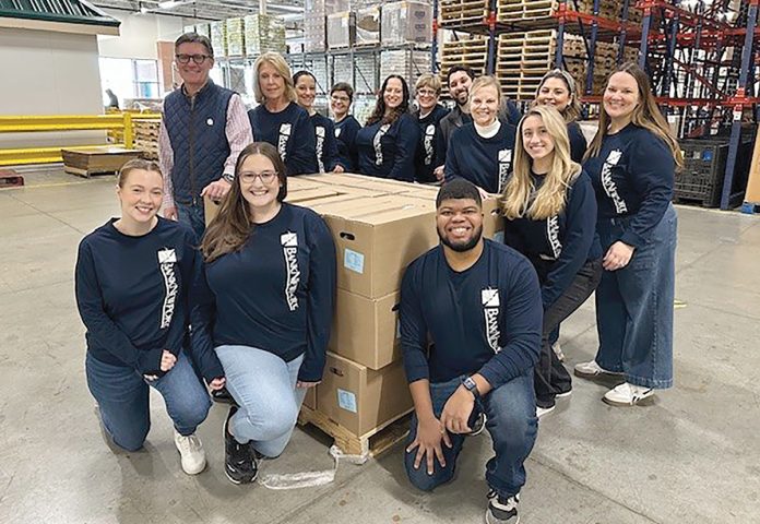 FOOD FOR THOUGHT: BankNewport team members volunteer at the Rhode Island Community Food Bank, assembling meal boxes for seniors.  COURTESY BANKNEWPORT