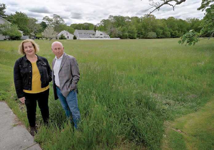FORGING AHEAD: East Bay Community Development Corp. Executive Director Diane Mederos, left, and consultant Frank Spinella stand at the future site for Penny Lane, a 40-unit affordable housing project planned along Child Street in Warren. Neighbors opposed the plans, but it eventually gained approval in part because the town’s ratio of affordable housing is too low.  PBN PHOTO/MICHAEL SALERNO