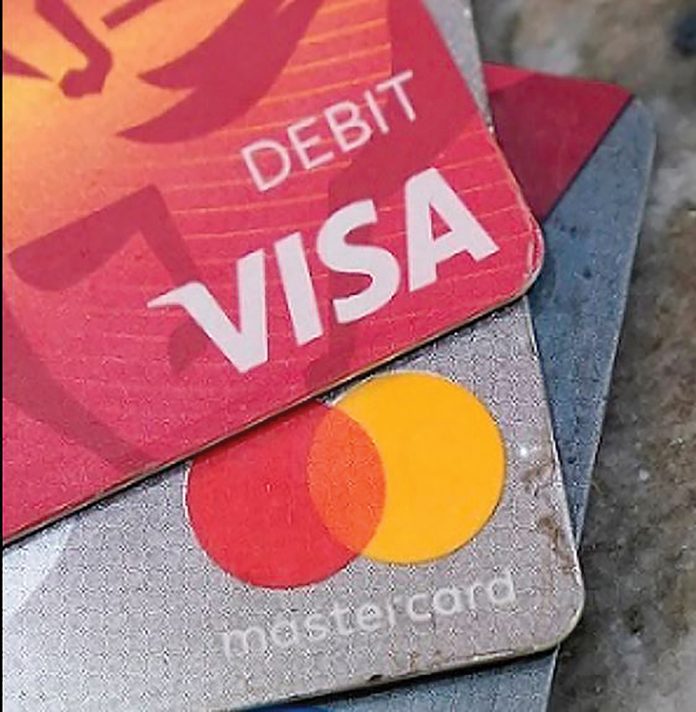CHANGE COMING? Visa Inc.. and Mastercard Inc. dominate credit card payment processing, but a bill in Congress is aiming to change that with the hope of reducing fees for merchants.  AP FILE PHOTO/STEVE HELBER