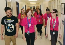 ON THE MOVE: Some of the newest members of the Rhode Island Federation of Teachers and Health Professionals make their way through the halls of the charter school Paul Cuffee School in Providence. They include, in front from left, Robert Capellan, third grade teacher; Sara Lefrancois-Vickey, fifth grade teaching partner; and Hannah Baker, kindergarten teacher. In the next row, from left, is Allison Merrill, first grade teacher; Andrea Lahlum, second grade teacher; and Noah Provost, second grade teacher. In the back is Stacy Gale, fourth grade teacher, and blocked from view is Jennifer Bifulco, third grade teacher. PBN PHOTO/ELIZABETH GRAHAM