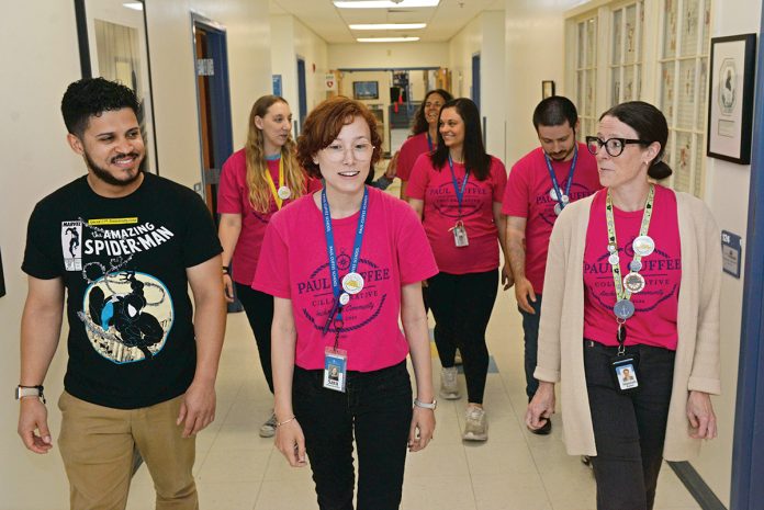 ON THE MOVE: Some of the newest members of the Rhode Island Federation of Teachers and Health Professionals make their way through the halls of the charter school Paul Cuffee School in Providence. They include, in front from left, Robert Capellan, third grade teacher; Sara Lefrancois-Vickey, fifth grade teaching partner; and Hannah Baker, kindergarten teacher. In the next row, from left, is Allison Merrill, first grade teacher; Andrea Lahlum, second grade teacher; and Noah Provost, second grade teacher. In the back is Stacy Gale, fourth grade teacher, and blocked from view is Jennifer Bifulco, third grade teacher. PBN PHOTO/ELIZABETH GRAHAM