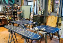 LEAVING HIS MARK: Providence Painted Signs owner Shawn Gilheeny works in his Marvin Street studio. His signature work can be seen throughout the capital city and beyond.  PBN PHOTO/MICHAEL SALERNO