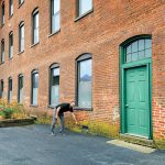 ON THE MARK: Richard Grundy, CEO and president of AVTECH Software Inc., indicates the level of floodwater at Cutler Mill in Warren, where AVTECH’s offices are located.  PBN PHOTO/MICHAEL SALERNO