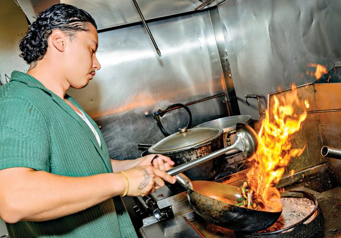 HOT SPOT: Chef Subat Dilmurat, owner of Jahunger LLC, a Uyghur restaurant in Providence, prepares one of his signature dishes, Jahunger Noodles.  PBN PHOTO/MICHAEL SALERNO