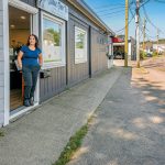 HIDDEN HAZARD: Claudia Conley, owner of Claudia’s Furry Tailz Pet Spa LLC, stands in the doorway at the spa on Market Street on a dry summer day. She says she lost two days of business last winter because of flooding. PBN PHOTO/MICHAEL SALERNO