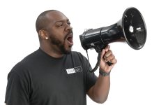 the prop Adewole T. “Wole” Akinbi holds a megaphone, calling it his “favorite and most-effective tool” to use with groups of 30 or more people.
