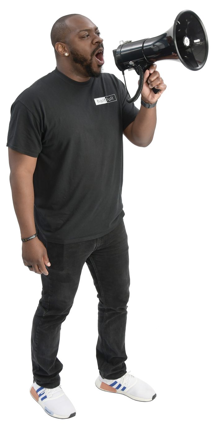 the prop Adewole T. “Wole” Akinbi holds a megaphone, calling it his “favorite and most-effective tool” to use with groups of 30 or more people.