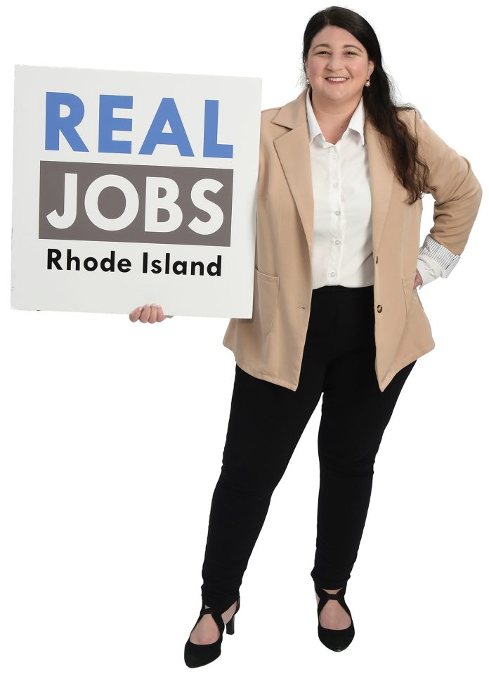 the prop Alyssa Alvarado holds the
Real Jobs Rhode Island sign, symbolizing her decade-plus time working to grow the state’s workforce development program. the prop Alyssa Alvarado holds the
Real Jobs Rhode Island sign, symbolizing her decade-plus time working to grow the state’s workforce development program.
