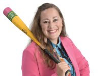 the prop Britney Crisafulli holds a baseball bat, representing both her time playing the game with her family and also volunteering at the local ball fields.