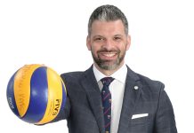 the propS William Maxwell Daley stands with a copy of Ron Chernow’s “Hamilton” book; a toy Porsche 911; a painting of his dog, Sophia, 8; and a Fédération Internationale de Volleyball game ball from when he competed in professional volleyball after college.