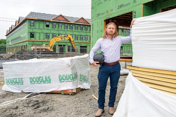 UNDER CONSTRUCTION: Taction Properties principal developer Derek Mesolella visits the site of a mixed-use development on West Main Road in Middletown that has been in the works for more than five years, but he hopes that recently approved legislation modifying the state building code will help to reduce the red tape associated with housing production in Rhode Island.  PBN PHOTO/DAVID HANSEN