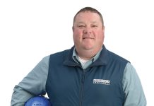 the prop Sean Lamontagne holds his Pariseault Builders Inc. construction hard hat.