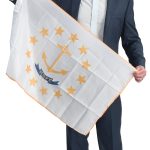 the prop Eric Lichatin holds the Rhode Island state flag, defining where he’s from and who he is.