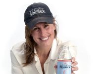 the prop Kelley McShane poses with bottles of iced tea produced at her company.